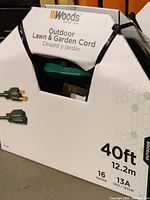 Woods branded original packaging showing 40ft length, 12.2m, 16 gauge, 13 amp, 125V 1625W rating