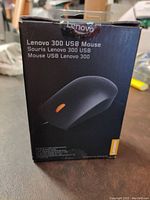 Front of the Lenovo 300 USB Mouse black box showing image of mouse and branding.