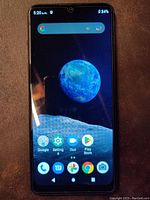 Front view of the ZTE smartphone powered on, showing the Android home screen and large 6.35 inch display.