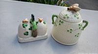 Photo showing both the sugar dish with lid and the salt and pepper set featuring bee and clover design