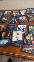 Blu-ray movie lot arranged on a wooden surface showing titles like Harry Potter, Skyfall, Looper, Argo.