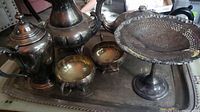 Seven-piece copper electroplated tea service, including teapot, water pot, sugar bowl, creamer, serving tray, and elevated pierced serving platter.