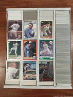 Top-down image of four compartments filled with baseball cards, showing some front cards featuring players in uniform from the late 80s and early 90s.