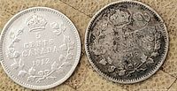 Obverse and reverse of 1912 and 1913 Canadian silver 5 cent coins on a beige surface showing detailed engravings and wear.