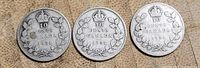 Reverse sides of three 1931 Canadian silver dimes showing denomination and wreath design