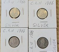 Obverse side of four 1966 Canadian silver dimes showing Queen Elizabeth II profile with handwritten annotations on holders.