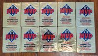 10 unopened packs of McDonald's MVP Bonus baseball cards arranged on a wooden floor, showing the packaging front with logo and text details.