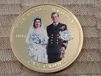 Full view of the one crown coin showing the color image of Royal Wedding couple and gold plated border with text.