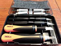 Open view of carving knife handles with blades stored in black plastic case