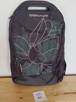 Front view of Golla laptop backpack showing floral print and integrated handle