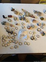 Top-down view of various costume rings arranged on a white surface.