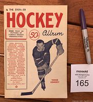 Front cover of the 1948-49 Hockey Album showing a photo of Teeder Kennedy with red and black typography.