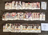 Wide shot showing stacks of various player cards arranged in rows, includes key players like Gordie Howe, Mark Messier, Wayne Gretzky and others.