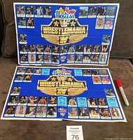 Two blue background posters showing the complete sticker set on one and near complete set on the other with stickers arranged in rows featuring various wrestlers.