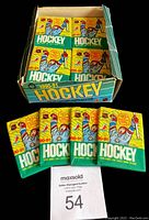 Top view of the wax box showing 30 unopened hockey card packs arranged evenly inside without the lid.