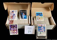 Two open cardboard boxes filled with 1990 Leaf baseball cards. Several cards displayed including Ken Griffey Jr., Frank Thomas, and a 'No Hit King' card of Nolan Ryan. Boxes are labeled for Series I and Series II.