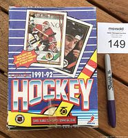 Front of the unopened 1991-92 OPC Hockey Card wax box with images of Ed Belfour and Mario Lemieux and original OPC tape seal.
