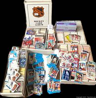 Loose cards in multiple monster boxes alongside binder and sealed vend pak box