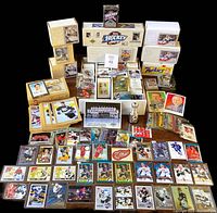 Overall view of lot with sealed box sets, individual cards, and loose cards laid out