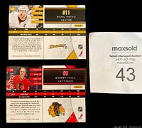 Front and back of Saku Koivu and Bobby Hull numbered hockey card inserts showing player images, stats, and team logos. Cards numbered out of 299.