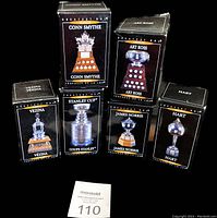 Six original black boxes for the NHL trophies, each labeled with the trophy name and image, arranged in two rows.