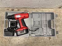 18V cordless drill with charger, battery, drill bits arranged in molded carrying case