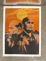 Full view of signed limited edition Breaking Bad print with two main characters illustrated in orange and black with sunset background.