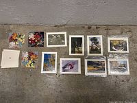Lot of decorative cards on floor showing various nature and floral photographs, some cards without sleeves and some stacked