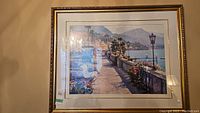 Front view of the framed Mediterranean coastal print showing the full artwork and gold decorative frame.