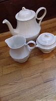 Photo showing the three-piece Royal Grafton tea set on wooden floor