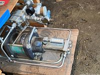 Close-up view of air compressor showing Breathing Air Service label and metal piping with valve and gauge details