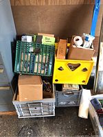 Four crates and boxes stacked containing assorted lighting components and bulbs.