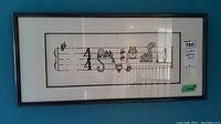 Framed limited edition print depicting musical notation with cats as notes. Shows artist's signature and edition number 77/290. Dimensions tag reads 12x26 inches.