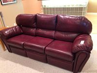 Front view of entire three-seat reclining sofa showing color and design
