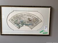 Full view of the framed limited edition print by Ian Kochberg showing the fan-shaped musical score and floral and butterfly design