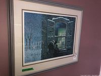 Framed print showing two children looking through a window on a snowy winter night.