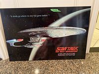 Front view of Star Trek: The Next Generation poster featuring USS Enterprise NCC-1701-D with quote and show title. Shows poster condition and size sticker.