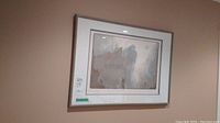 Photo showing framed limited edition print on wall with visible matting and silver frame.