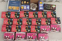 Photo showing 27 boxed LED light items including multiple red boxes labeled 'LED Decorative Lights', pink holiday-themed 'Cospo LED Light' boxes, and Vindany branded curtain lights.