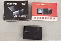 Two boxed dash cameras, one Focuway M3 4K and a Car Dash Cam A3, plus a Vantrue dash cam hardware kit box.