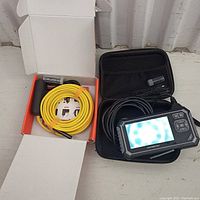 Both endoscope units shown together including the yellow cable endoscope and the digital LCD screen endoscope in case.