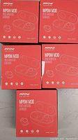 Five boxed sets of Mpow M30 True Wireless Earbuds in original factory packaging, arranged on a surface.