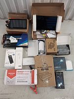Full lot image showing all items together including dashboard screens, car seat gap organizer box, pulse charger box, air pump, and other accessories.