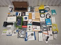 Wide view of all computer accessories including laptop battery, vacuum cleaner, cables, and printer.