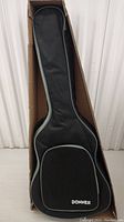Soft case for the guitar showing overall shape with zippered front pocket and Donner logo