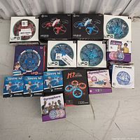 Photo showing entire collection of flying toys and boomerangs in original packaging on display surface.