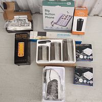 Full view of all items including phone, lamp, canisters, lint remover, cable concealers, door handle, and tumbler.