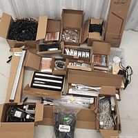 Wide view of all items spread out, showing string lights, copper wire coils, LED light bars, remotes, and adapters