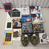 Full overview of 15 toy items including writing tablets, robot toys, launchers, masks and other toys