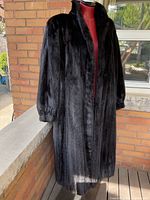 Front view of full-length black mink fur coat on mannequin